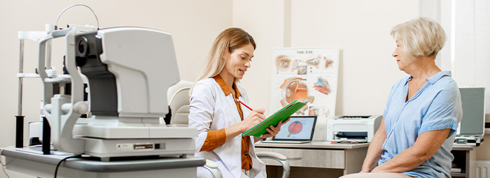Optometrist with patient in exam room