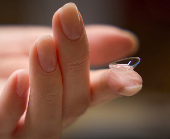 Holding a contact lens at the tip of the index finger